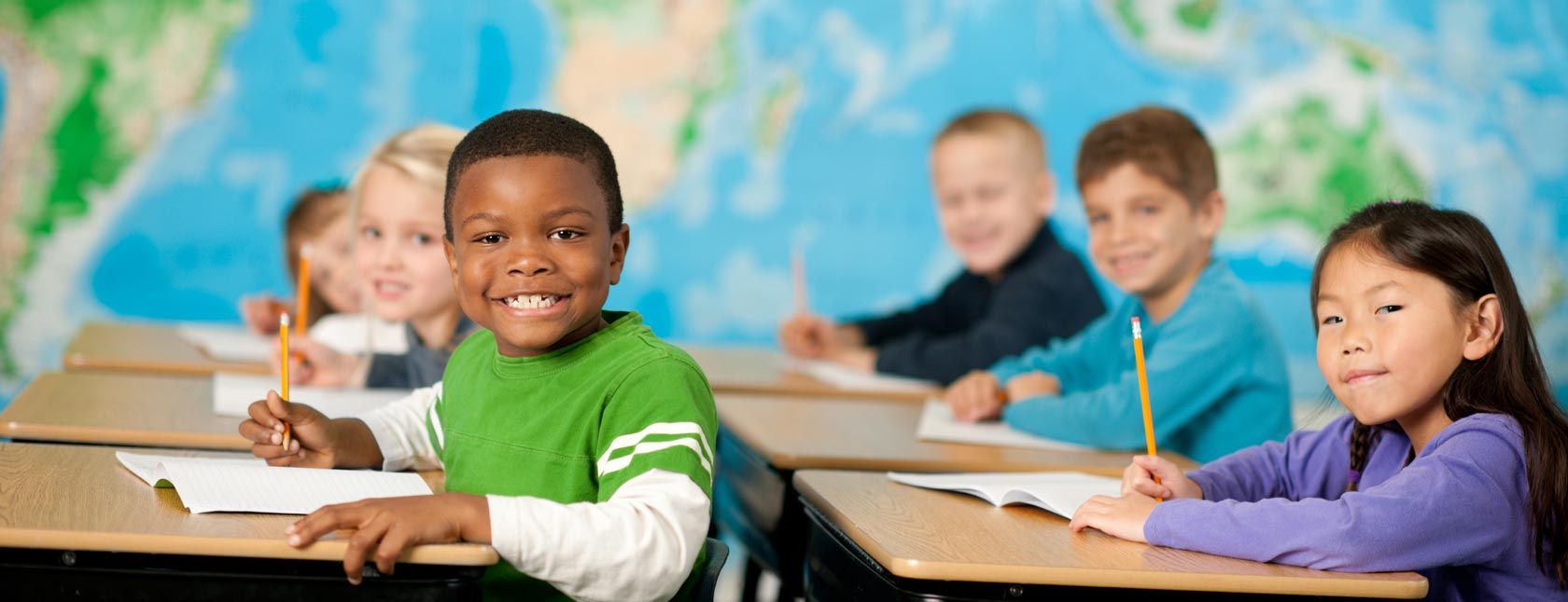 school children sitting at desks