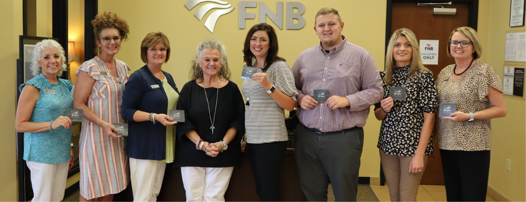 FNB Employees with Mayor Kathy O'Nan holding gift cards that were donated